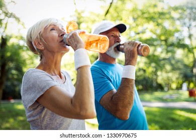 Senior couple staying hydrated after running jogging - Powered by Shutterstock