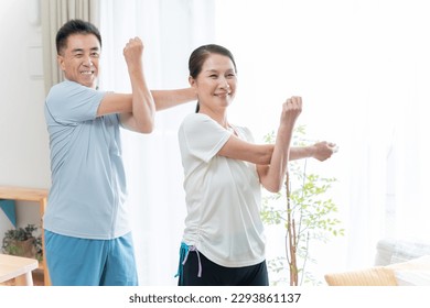 Senior couple stretching at home - Powered by Shutterstock