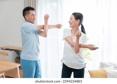 Senior couple stretching at home - Powered by Shutterstock