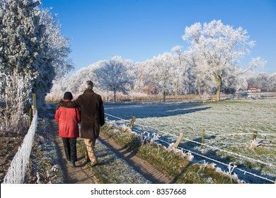 Senior Couple Strolling In A Winter Landscape