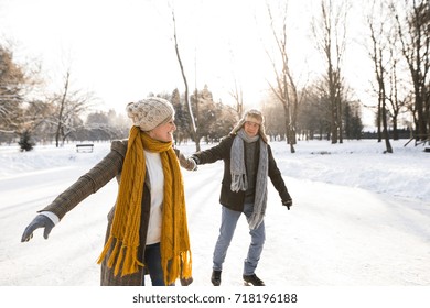 Senior Couple In Sunny Winter Nature Ice Skating.