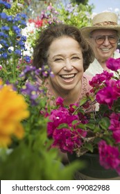 Senior Couple Surrounded By Flowers