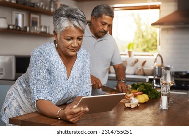 Senior couple, tablet and cooking in kitchen with healthy food, online search and app for nutrition in home. Digital recipe, old woman and man in house with meal prep, wellness and retirement diet. - Powered by Shutterstock