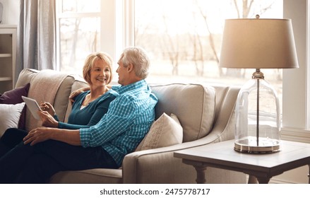 Senior couple, tablet and happy on sofa in conversation, decision and search on web in home living room. Old man, elderly woman and smile for choice with video, streaming and movie on couch in house - Powered by Shutterstock