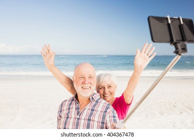 Senior couple taking selfie on the beach - Powered by Shutterstock