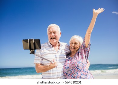 Senior couple taking selfie on the beach - Powered by Shutterstock