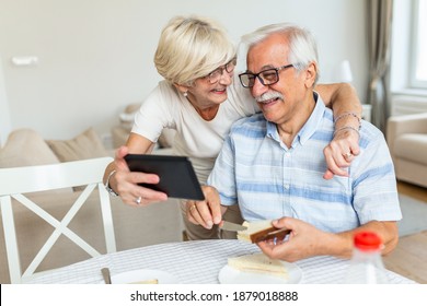 Senior couple taking a selfie with tablet. Elderly couple having a video call with friends or family using tablet. Old couple is talking online via video connection on the tablet. - Powered by Shutterstock