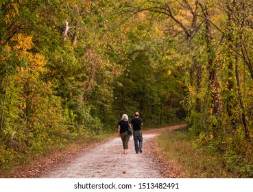 Senior Couple Taking A Walk On Trail By Missouri River Bluffs In Fall