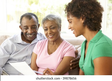 Senior Couple Talking To Financial Advisor At Home - Powered by Shutterstock