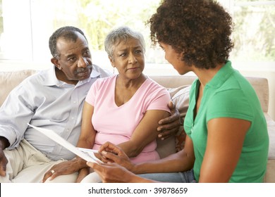 Senior Couple Talking To Financial Advisor At Home - Powered by Shutterstock