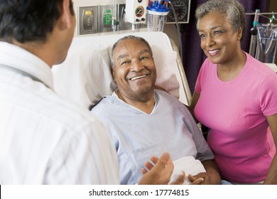 Senior Couple Talking,Smiling With Doctor - Powered by Shutterstock