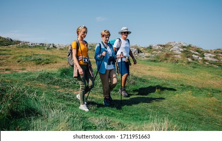 Senior couple with their daughter practicing trekking outdoors - Powered by Shutterstock