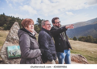 Senior couple with their son taking a walk in the mountain.  - Powered by Shutterstock