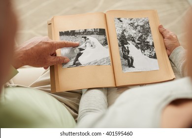 Senior Couple At Their Wedding Photos In Photo Album