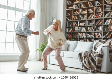 Senior Couple Together At Home Retirement Concept Dancing Active Dance Playful