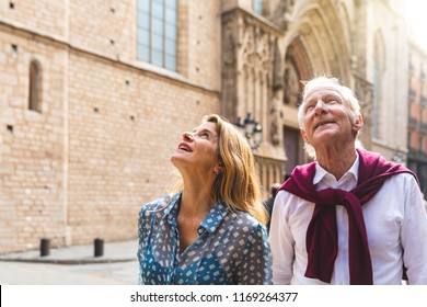 Senior couple of tourists visiting the old town in Barcelona. Adult woman and man looking up at some beautiful architecture on a sunny day in Spain. Travel and tourism concepts - Powered by Shutterstock