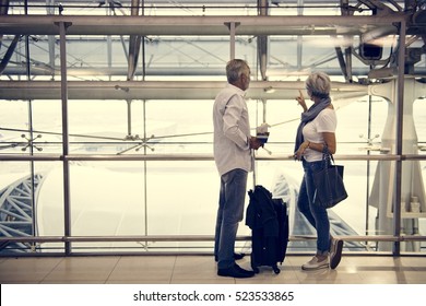 Senior Couple Traveling Airport Scene