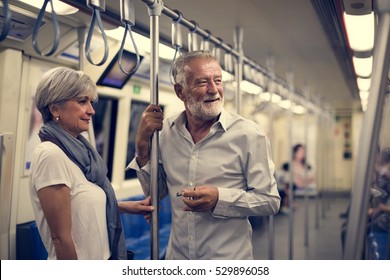 Senior Couple Traveling Inside Train Subway