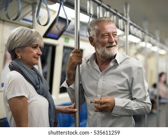 Senior Couple Traveling Inside Train Subway