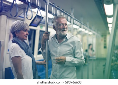 Senior Couple Traveling Inside Train Subway