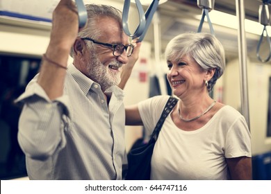 Senior Couple Traveling Inside Train Subway