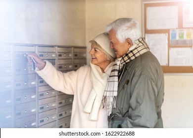 Senior Couple Unlocking Apartment Mailbox
