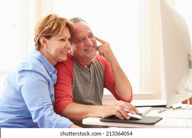 Senior Couple Using Computer At Home