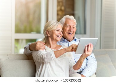 Senior Couple Using Digital Tablet At Home
