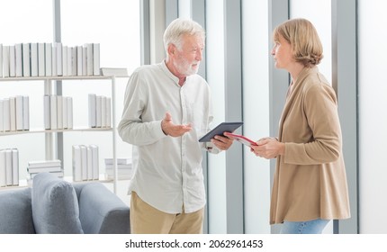 Senior Couple Using Digital Tablet At Home. Senior Adult Holding Tablet Reading Concept