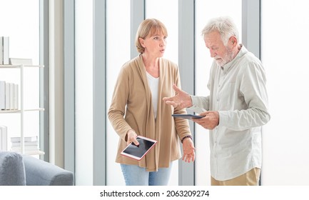 Senior Couple Using Digital Tablet At Home. Senior Adult Holding Tablet Reading Concept