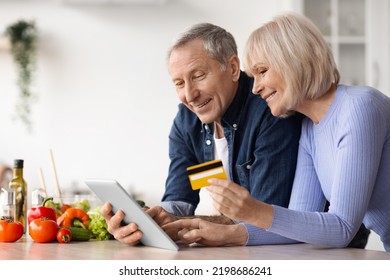 Senior Couple Using Digital Tablet And Credit Card, Cooking Together Healthy Vegetable Salad At Home, Happy Mature Man And Woman Making Lunch, Order Ingredients On Internet, Copy Space