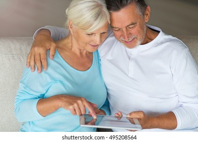 Senior couple using digital tablet