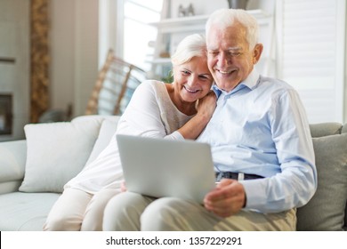 Senior couple using laptop computer at home
