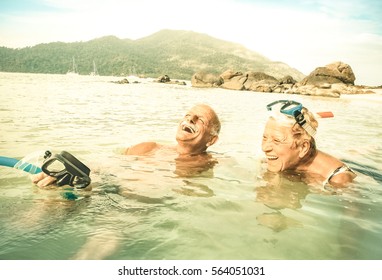 Senior Couple Vacationer Having Genuine Fun On Tropical Koh Lipe Beach In Thailand - Snorkel Tour In Exotic Scenario - Active Elderly And Travel Concept Around World - Warm Desaturated Greenery Filter