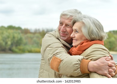 Senior Couple Walking In Autumn Park