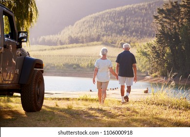 Senior Couple Walking By Lake At The End Of Road Trip - Powered by Shutterstock