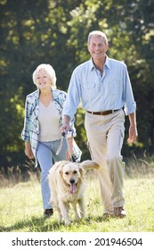 Senior Couple Walking Dog