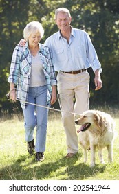 Senior Couple Walking Dog