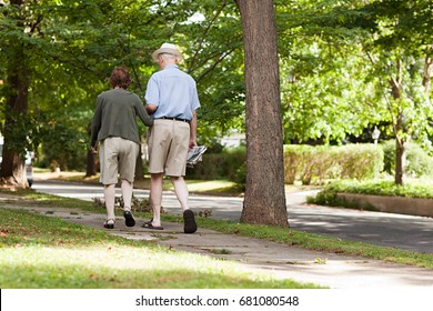 Senior couple walking in neighborhood - Powered by Shutterstock