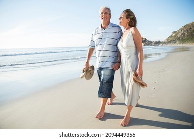 Senior Couple Walking On Beach