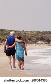 Senior Couple Walking On The Beach