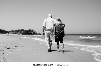 Senior Couple Walking On The Beach