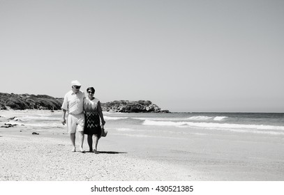 Senior Couple Walking On The Beach