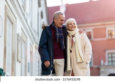 Senior Couple Walking On The City Street At Winter Day