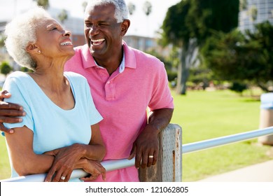 Senior Couple Walking In Park Together
