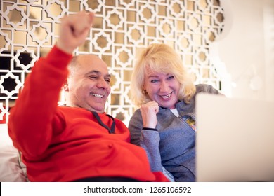 Senior Couple Watching A Movie On A Laptop Or Tv