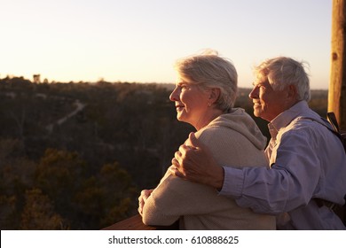 Senior Couple Watching Sunset From Observation Deck