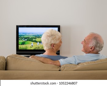 A Senior Couple Watching Tv And Talking