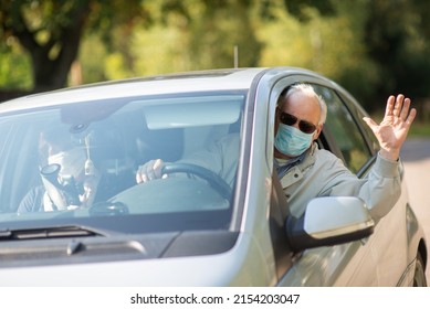 Senior Couple Wearing Anti Virus Masks Are Driving In A Car During The COVID-19 Pandemic