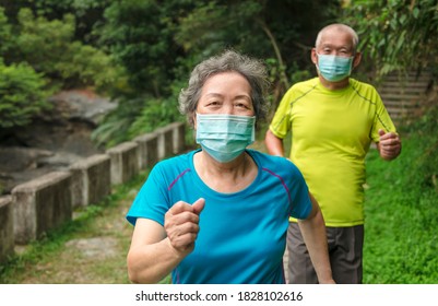 Senior couple wearing face mask and walking trough nature park - Powered by Shutterstock